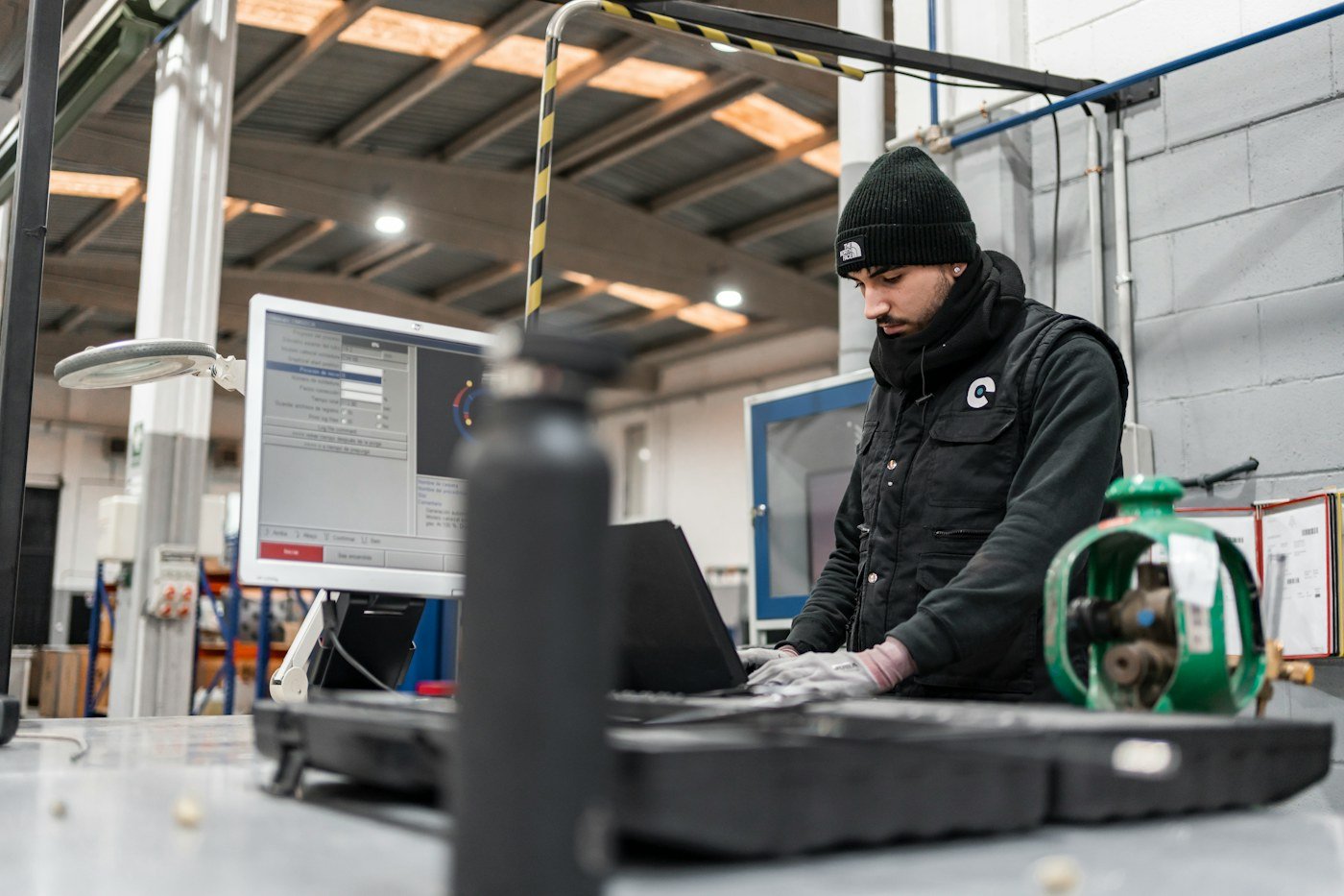 Industrial technician using diagnostic equipment at a technical workstation